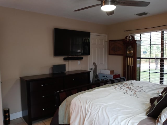 tiled bedroom with ceiling fan