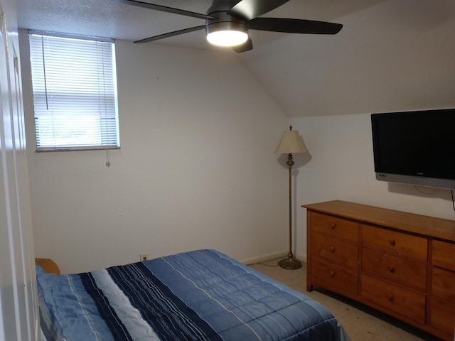 bedroom featuring vaulted ceiling, ceiling fan, and light colored carpet