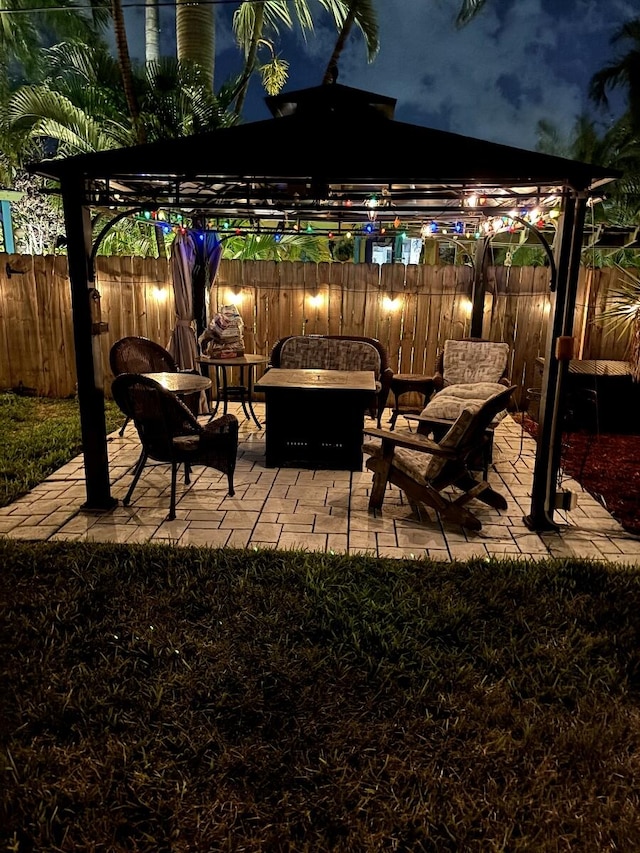 5266 Greenwood Dr, Delray Beach, FL 33484 - patio at twilight with a fenced backyard and a fire pit