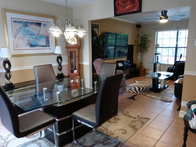 dining space featuring light tile patterned floors and ceiling fan with notable chandelier