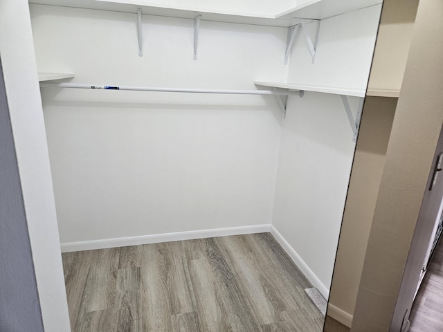 spacious closet featuring hardwood / wood-style floors