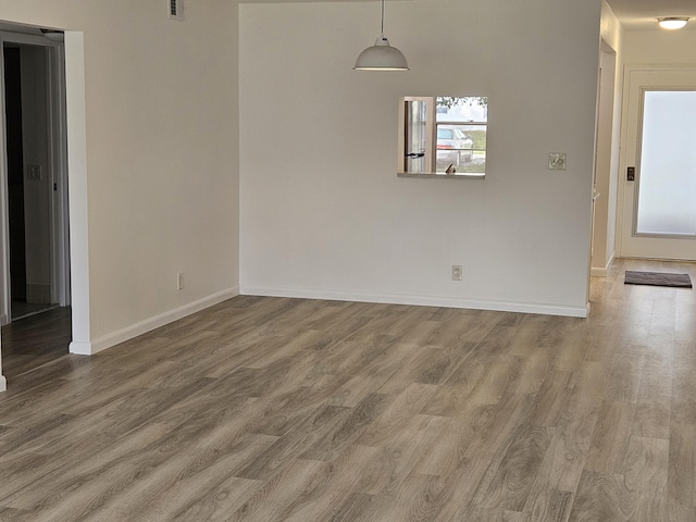 unfurnished dining area featuring plenty of natural light and hardwood / wood-style floors