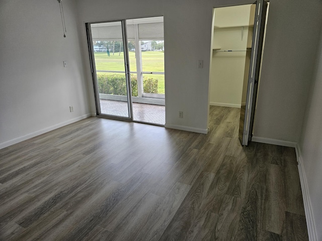 empty room with dark wood-type flooring