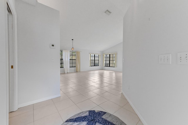 interior space featuring high vaulted ceiling and light tile patterned floors