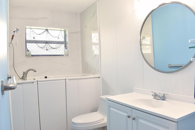 bathroom featuring toilet and vanity