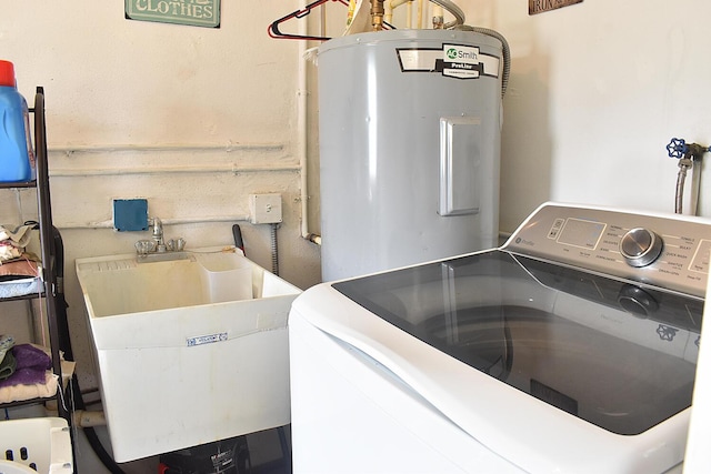 laundry room featuring electric water heater, washer / clothes dryer, and sink