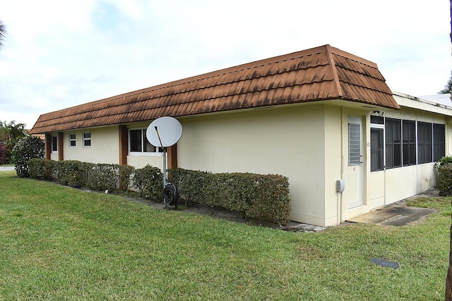 view of side of home featuring a lawn