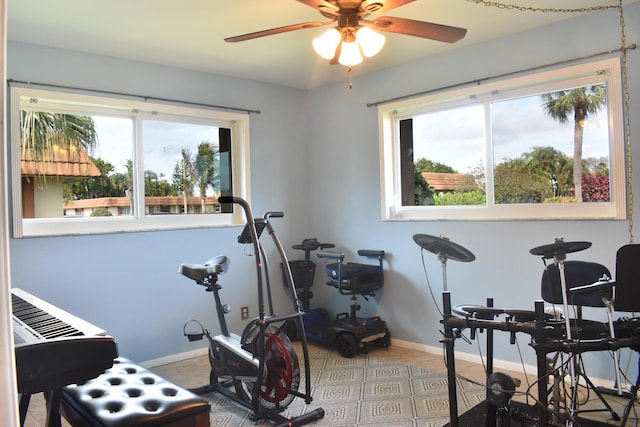 exercise room with ceiling fan and a wealth of natural light