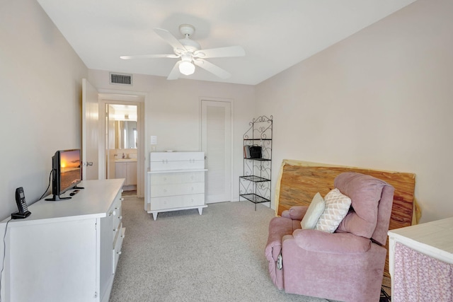 sitting room with ceiling fan, light colored carpet, and sink