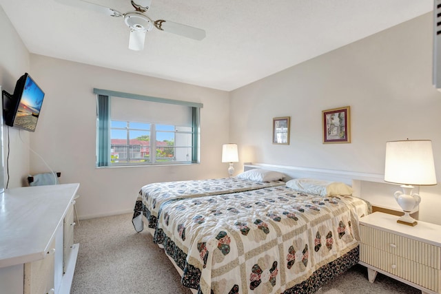 bedroom with ceiling fan and light colored carpet