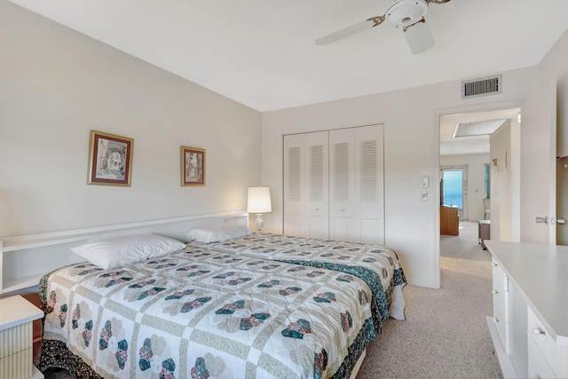 bedroom featuring ceiling fan, a closet, and light colored carpet