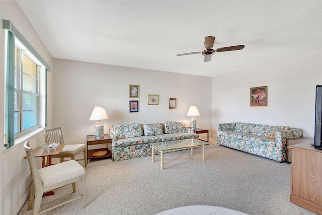 living room featuring ceiling fan, plenty of natural light, and a textured ceiling