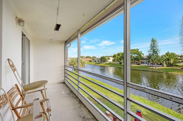 unfurnished sunroom with a water view