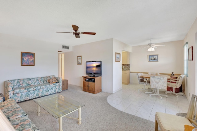 living room featuring ceiling fan and light tile patterned floors