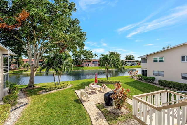 view of yard with a patio area and a water view