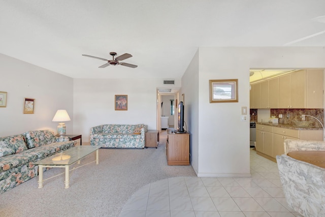 living room featuring ceiling fan and light colored carpet