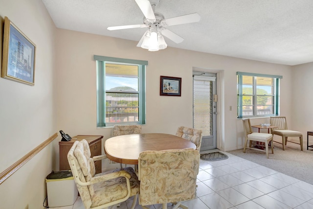 dining room featuring plenty of natural light, a textured ceiling, and light tile patterned floors