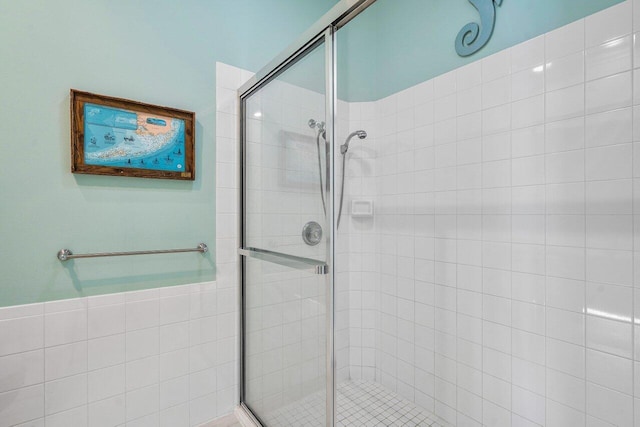 bathroom featuring a shower with door