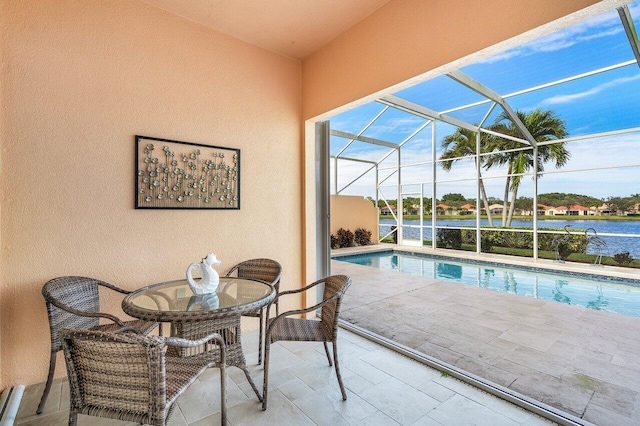 view of swimming pool with glass enclosure, a patio area, and a water view