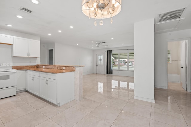 kitchen with ceiling fan with notable chandelier, electric stove, white cabinets, and kitchen peninsula