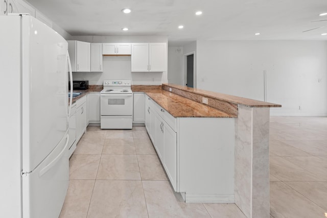 kitchen featuring white appliances, white cabinetry, kitchen peninsula, light tile patterned flooring, and stone counters