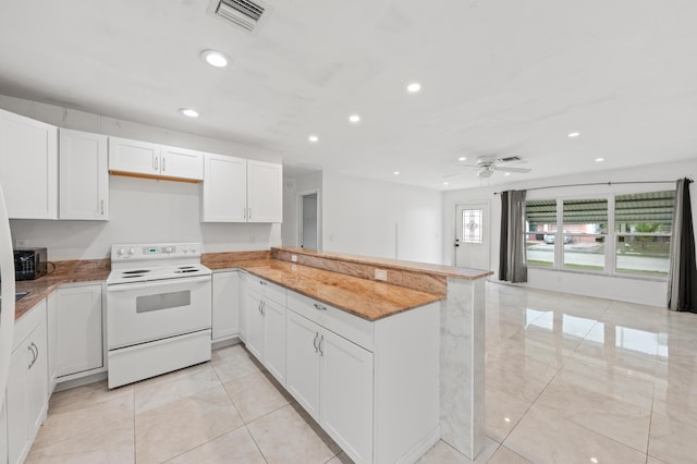 kitchen with ceiling fan, electric range, white cabinets, and kitchen peninsula