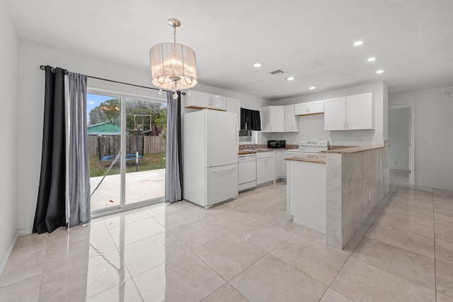 kitchen featuring white cabinetry, kitchen peninsula, and white appliances