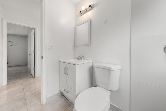 bathroom featuring a textured ceiling, tile patterned floors, vanity, and toilet