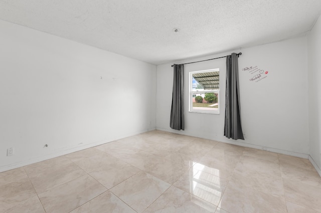 empty room with a textured ceiling