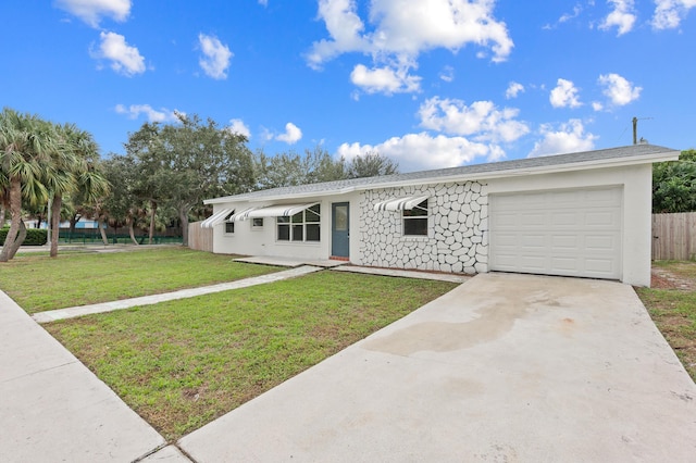 single story home featuring a garage and a front lawn