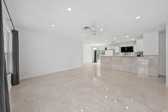 unfurnished living room with ceiling fan