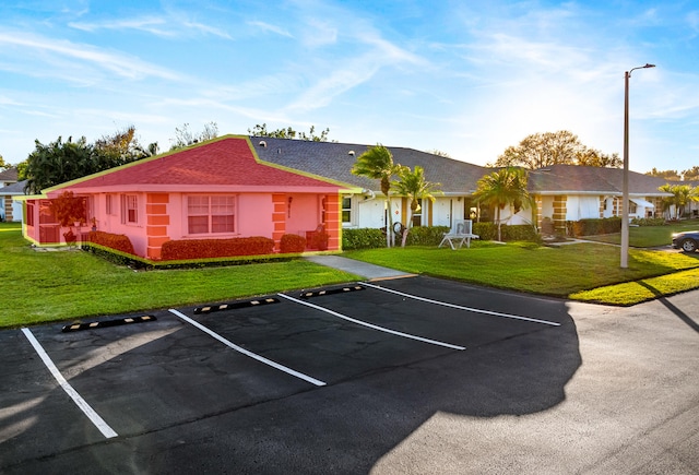 view of vehicle parking featuring a yard