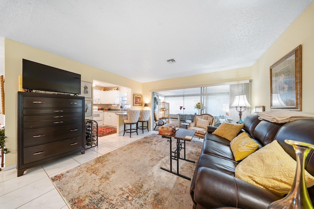 tiled living room with a textured ceiling