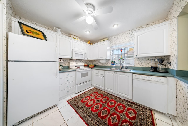 kitchen featuring white cabinetry, ceiling fan, white appliances, light tile patterned flooring, and sink