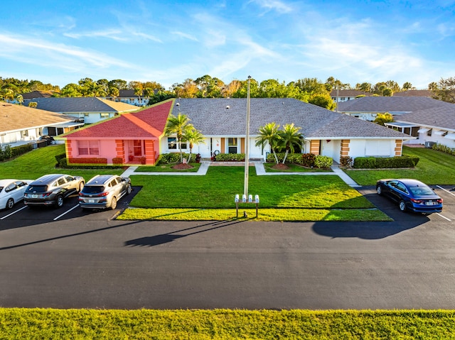 ranch-style home with a front lawn