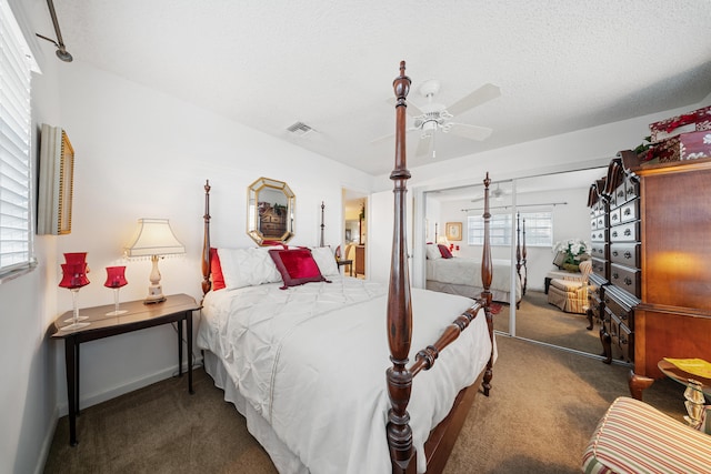 carpeted bedroom with ceiling fan, a textured ceiling, and a closet