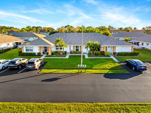 ranch-style home with a front yard