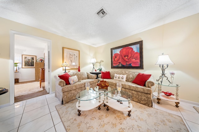 living room with a textured ceiling and light tile patterned flooring