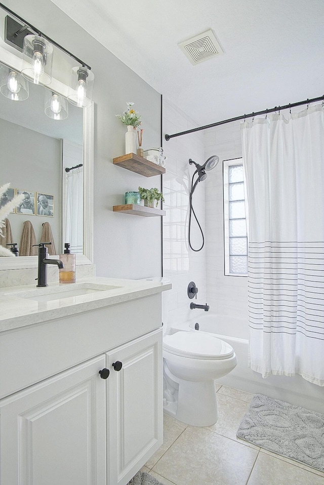 full bathroom featuring shower / bath combo with shower curtain, tile patterned floors, toilet, and vanity