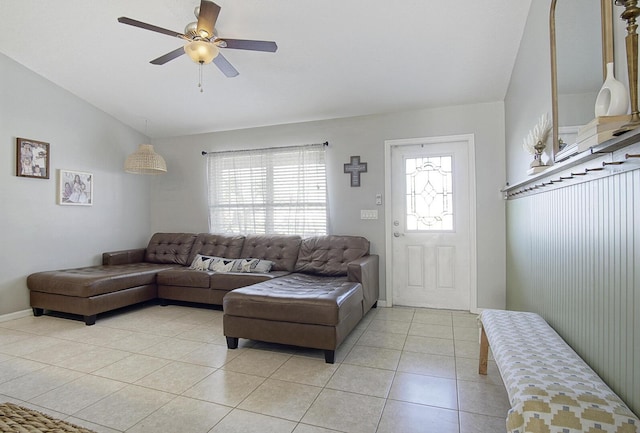 living room with ceiling fan, light tile patterned floors, and lofted ceiling