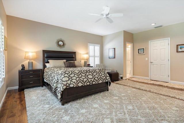 bedroom with baseboards, visible vents, a ceiling fan, and wood finished floors