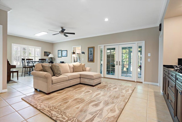 living room featuring french doors, ceiling fan, crown molding, and light tile patterned floors