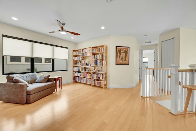 sitting room with ceiling fan and light wood-type flooring