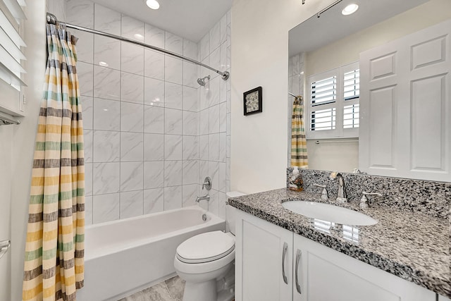 full bathroom with vanity, toilet, and shower / bath combo with shower curtain