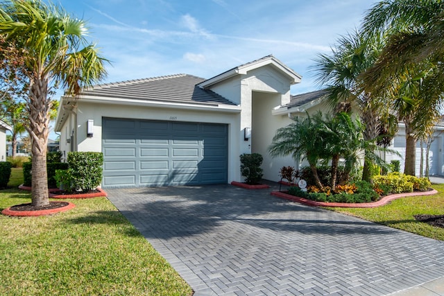 view of front of home with a garage and a front lawn