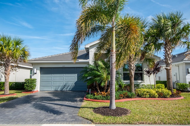 view of front of home with a front yard and a garage