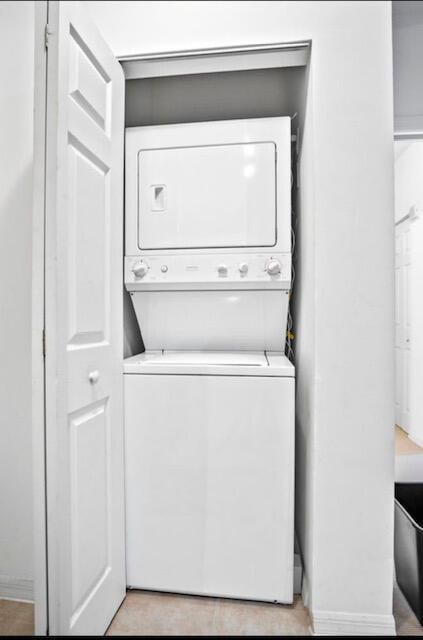 laundry room with stacked washer / dryer