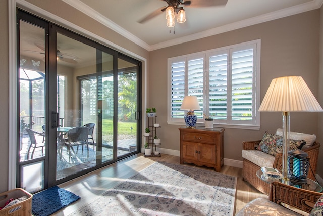 doorway featuring light wood-type flooring, ceiling fan, french doors, and ornamental molding