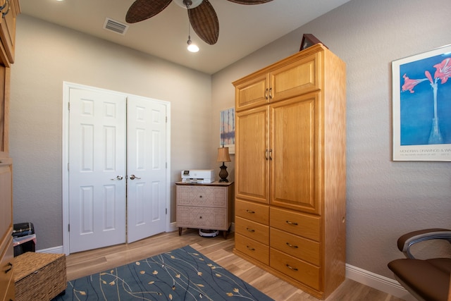 bedroom with a closet, ceiling fan, and light hardwood / wood-style flooring