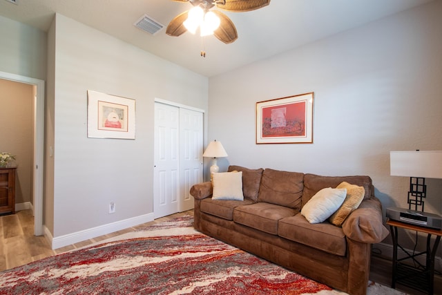 living room with light wood-type flooring and ceiling fan